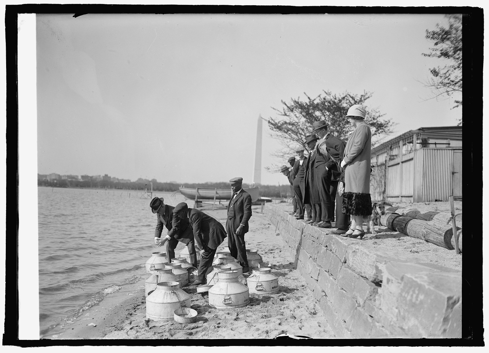 Fish Commissioner Henry O'Malley stocking Tidal Basin, [Washington, D.C.], with fish, 4, [19]25 April 16. — historic photograph