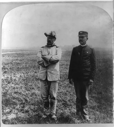 [Theodore Roosevelt, full, standing, with Dr. Cross (in Cav. off. unif.)]
