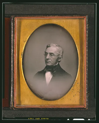 Daguerreotype portrait of a man with spectacles in oval mat