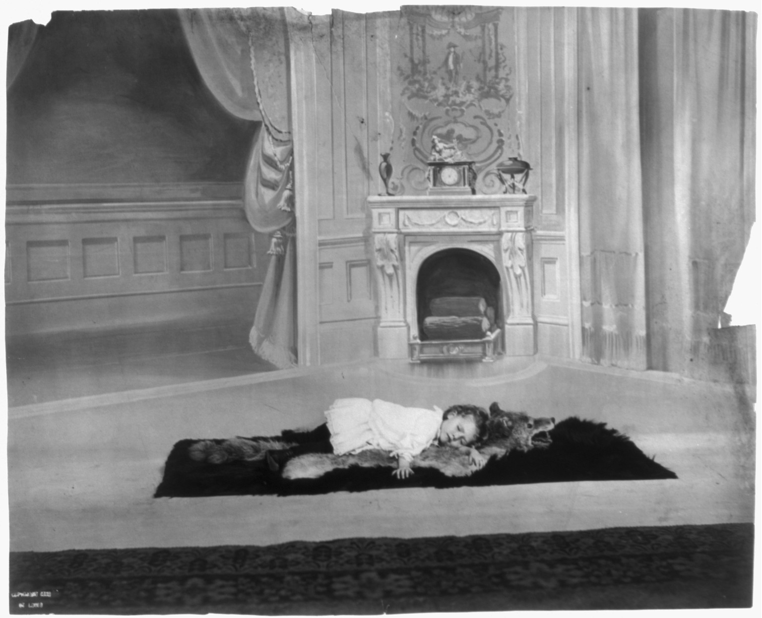 [Child sleeping on wolfskin rug], [ca. 1900-10] — historic photograph