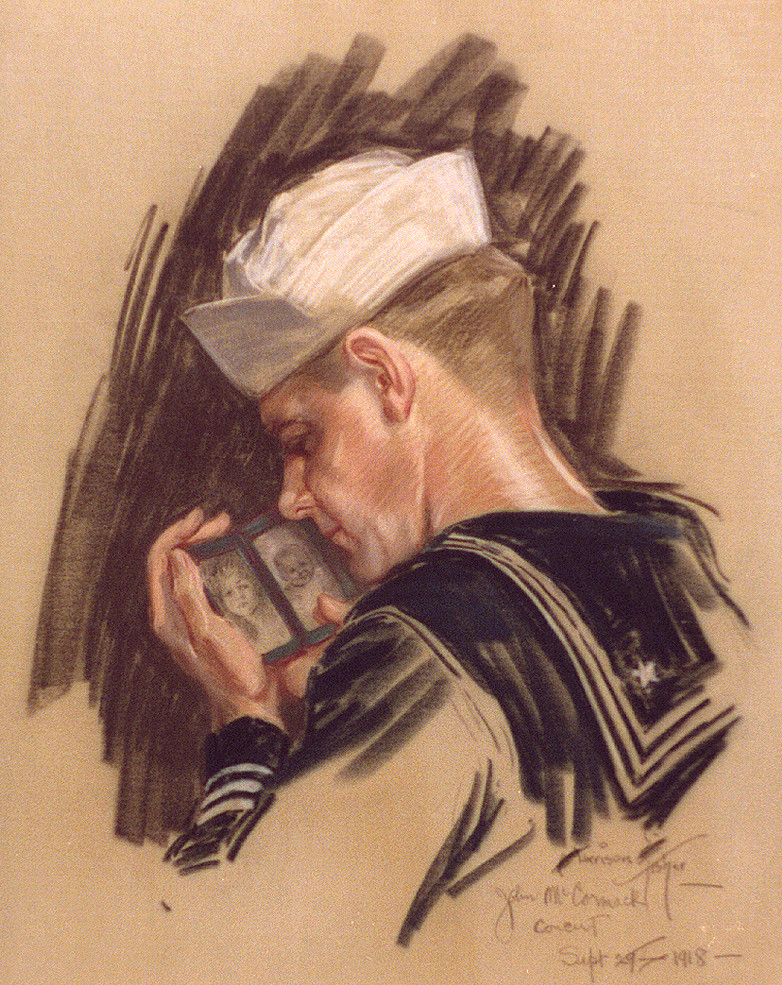Sailor in white cap gazing at small family photographs — historic photograph
