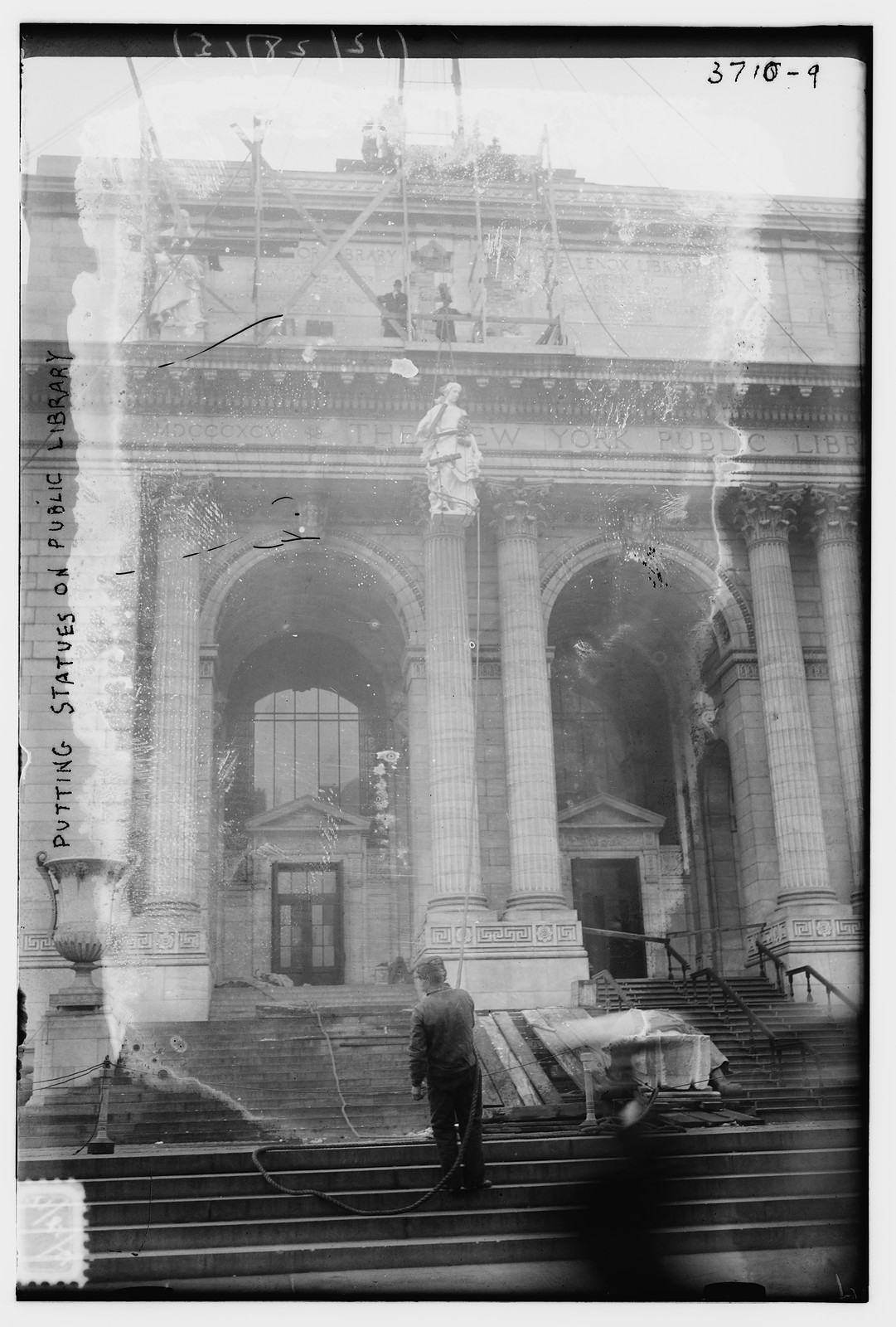 Putting statues on public library, n/a — historic photograph