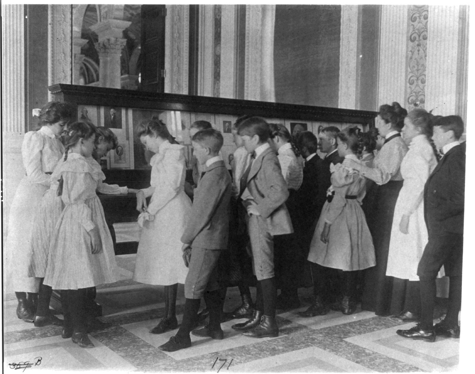 [Washington, D.C. public schools - museum field trip - viewing exhibit case of George Washingtoniana], [1899?] — historic photograph