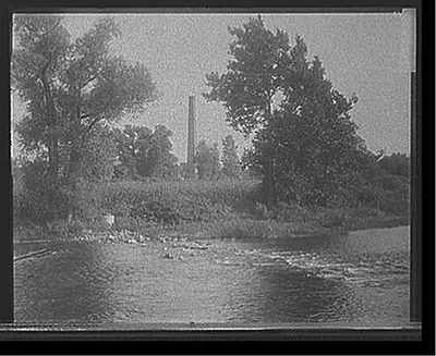 [Smokestack by river, probably the Huron River, Ypsilanti, Michigan]