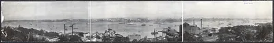 Panoramic harbor view with ships and city shoreline