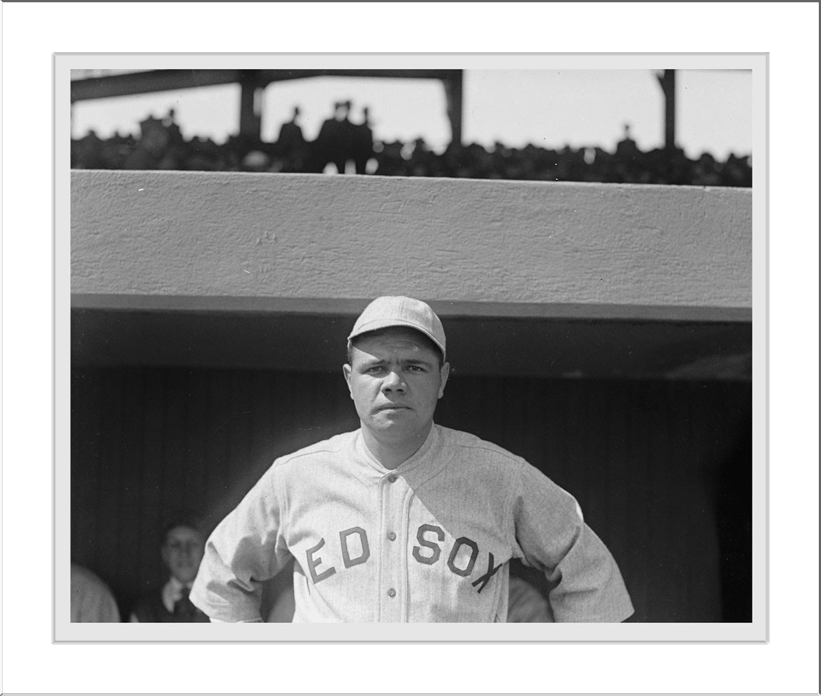 Baseball player in Red Sox uniform in dugout — historic image