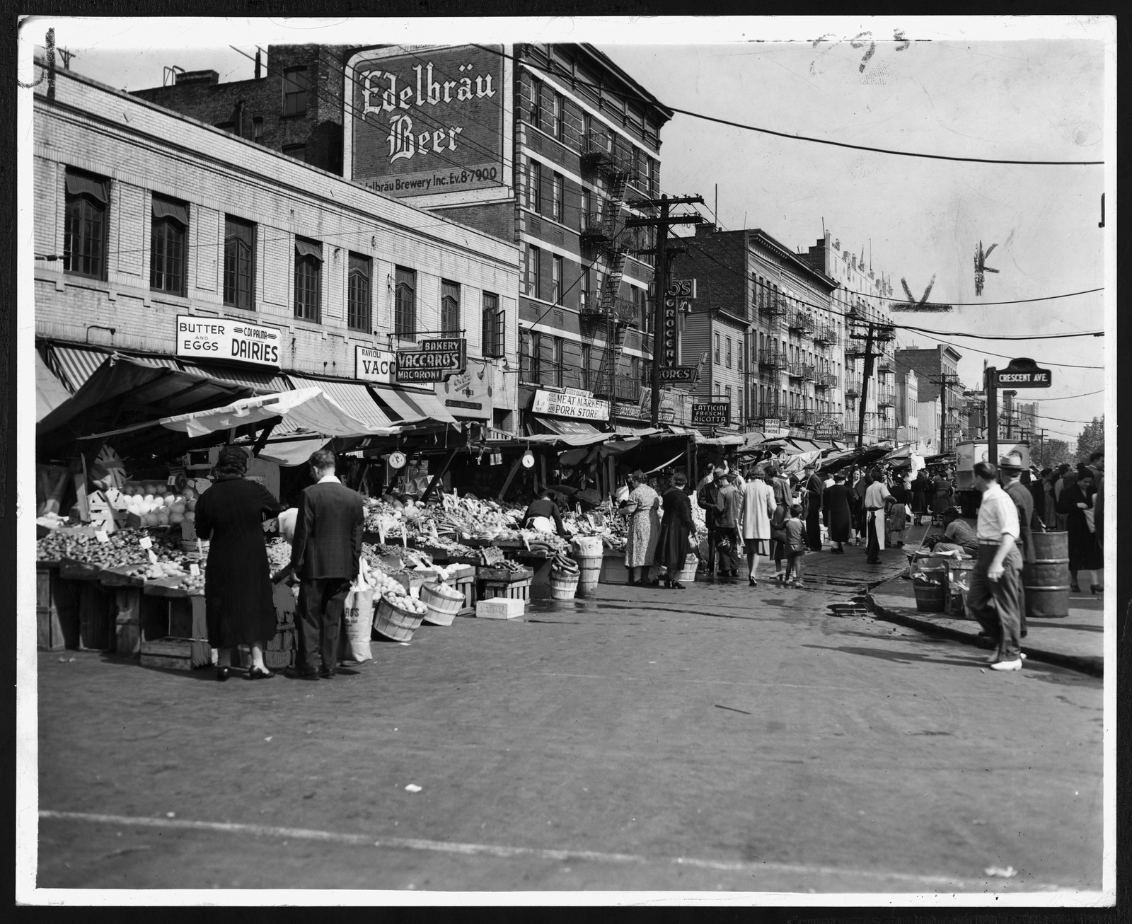 Busy city street market with produce stalls and Edelbräu Beer sign — historic image