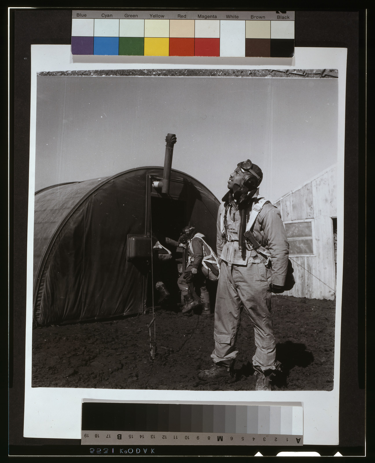 [Black fighter pilot series--pilot with parachute room in background, Ramitelli, Italy], [1945 March] — historic photograph