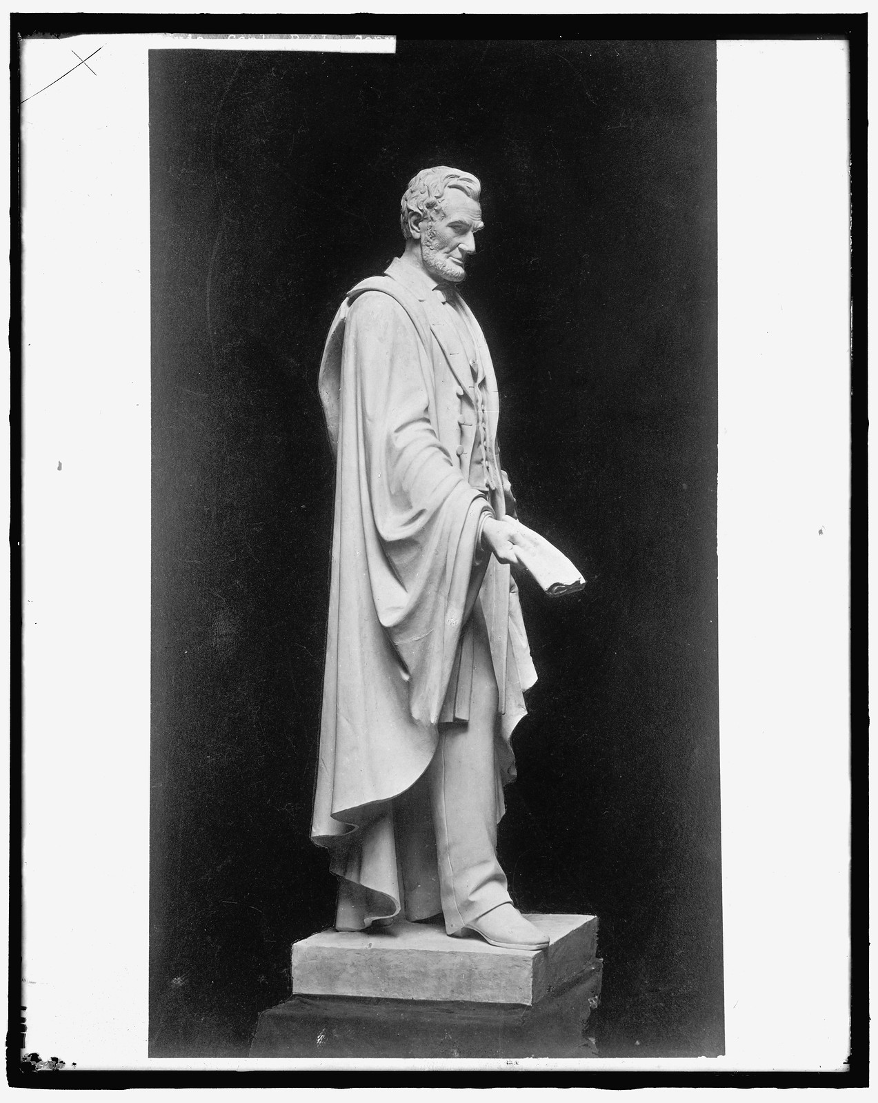 Marble statue of Abraham Lincoln holding a scroll — historic image