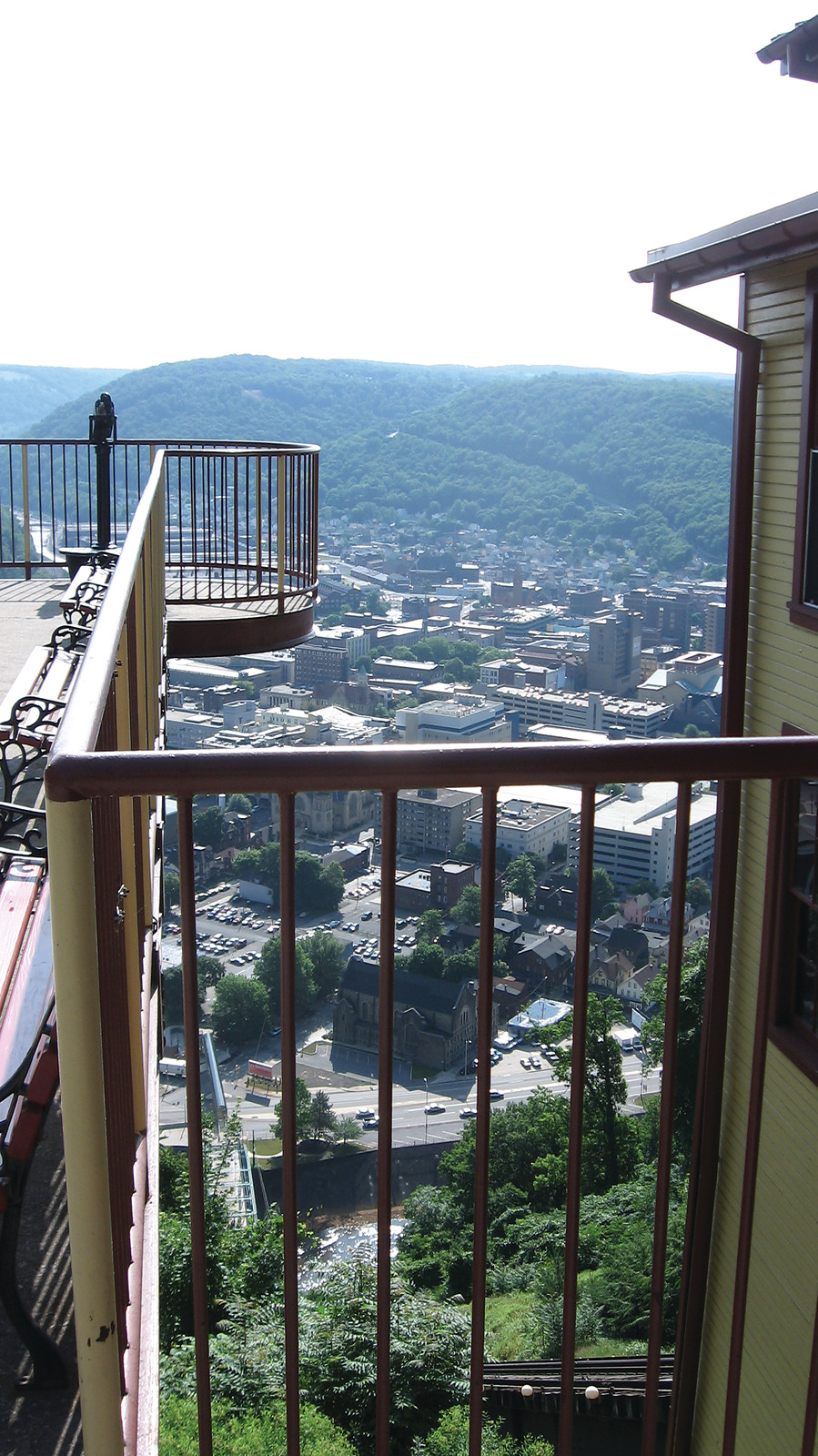 Hilltop view over a valley town from a railed deck — historic image