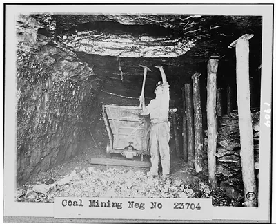 [Miner working in coal mine]