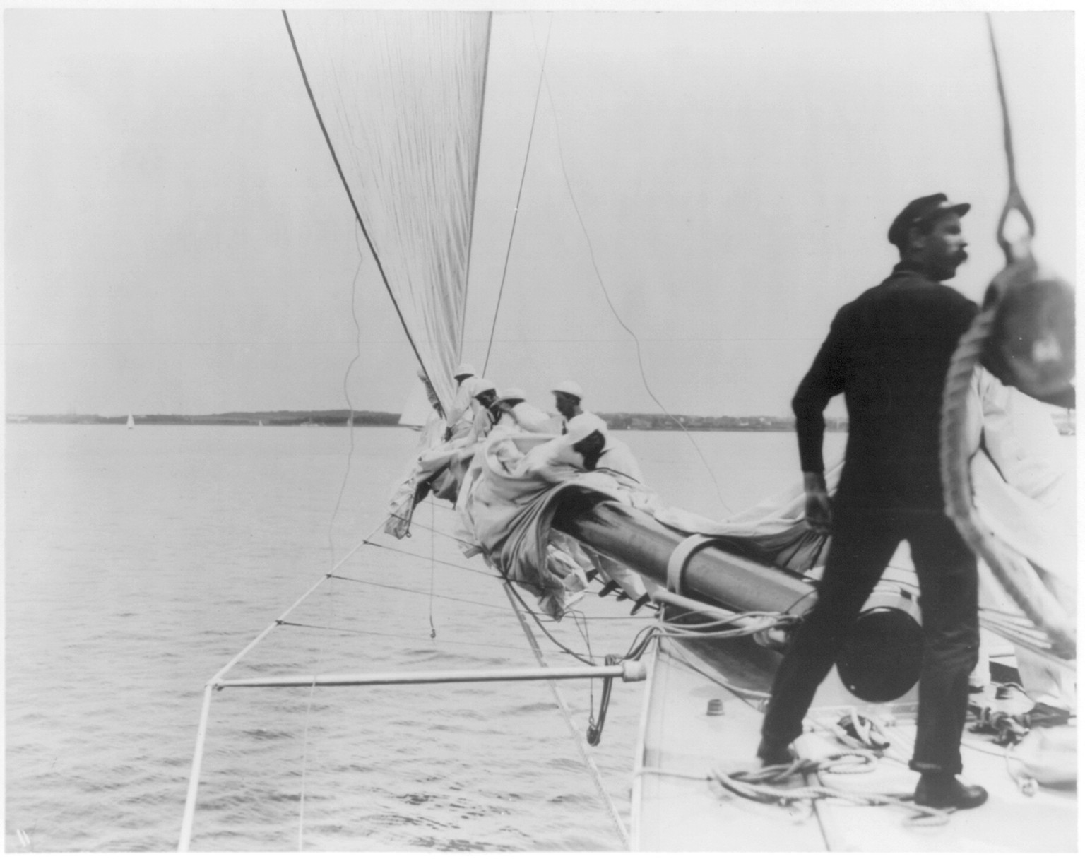 [Photo of the sailing yacht RELIANCE: furling the jib] — historic photograph