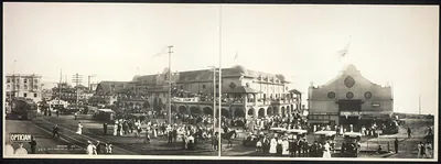Panoramic view of a seaside resort with crowds and trolleys