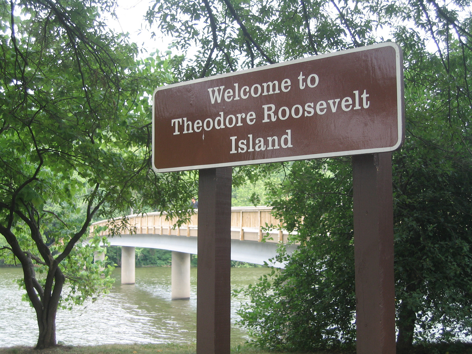 Brown park sign welcoming visitors to Theodore Roosevelt Island — historic image