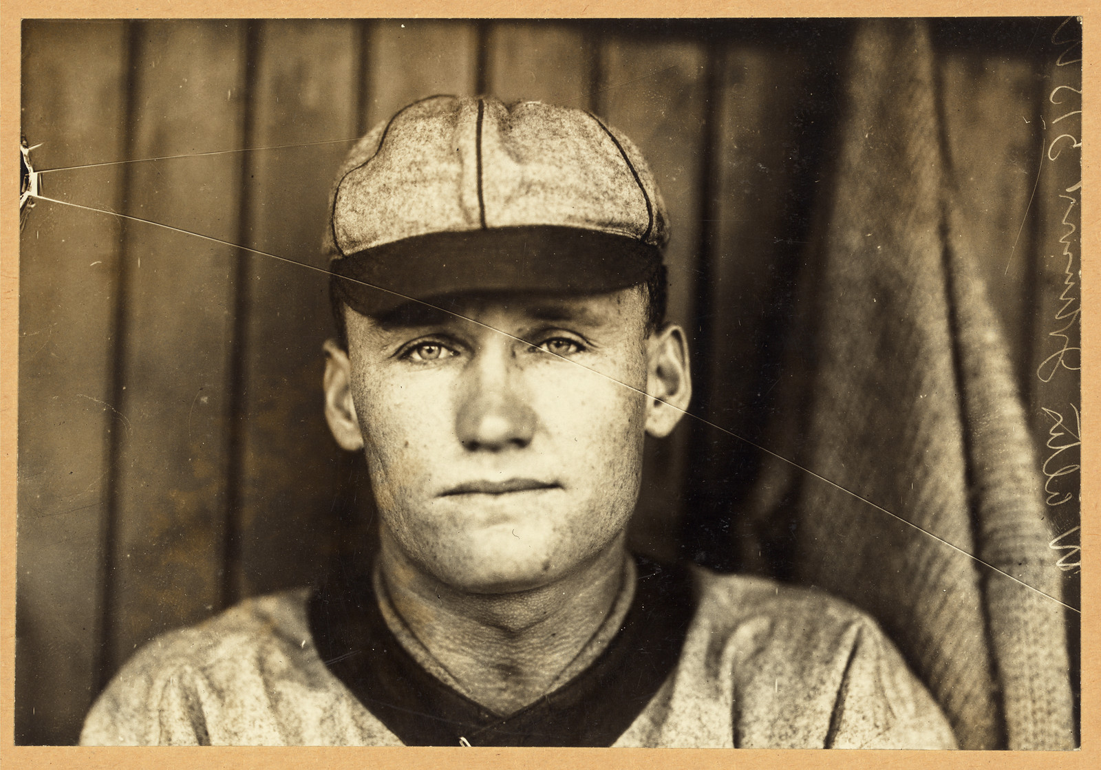 Sepia portrait of a baseball player in cap and jersey — historic image