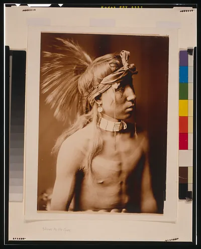 [Shows As He Goes, half-length portrait, facing right, bare chested]