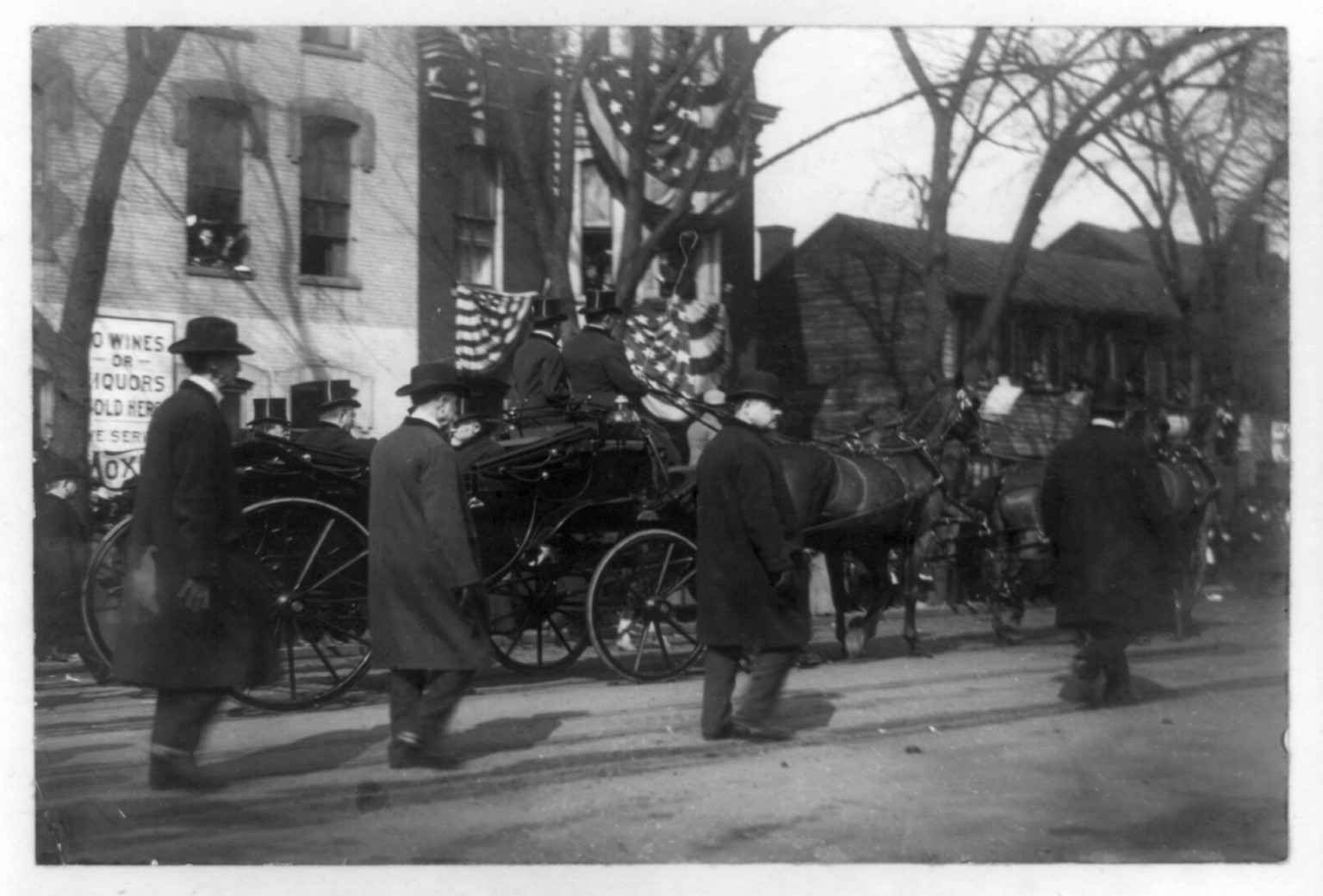 [Theodore Roosevelt and 2 other men in horse-drawn carriage, men walking along side, during inauguration day], c1905. — historic photograph