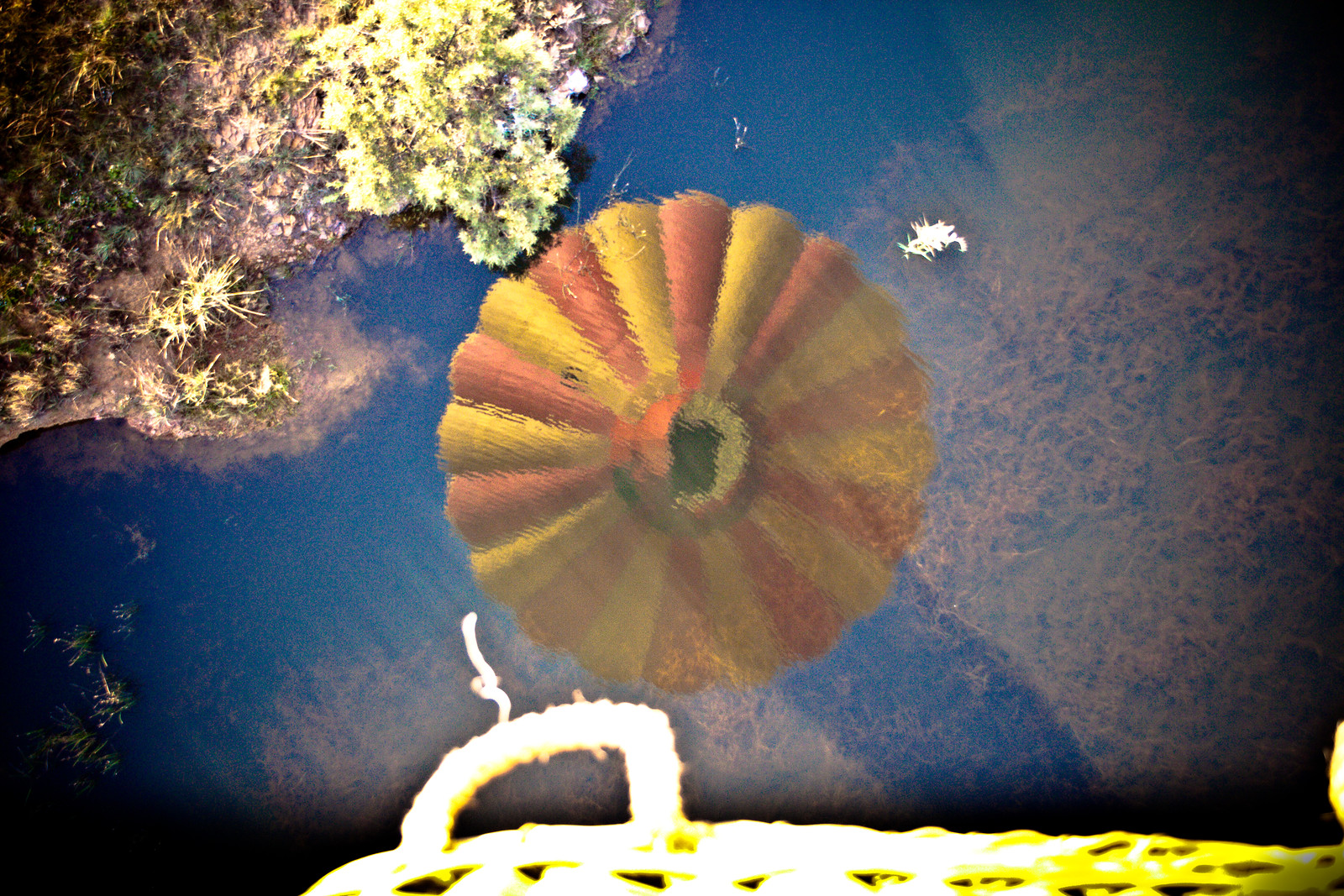 Striped circular reflection on dark water with yellow edge — historic image