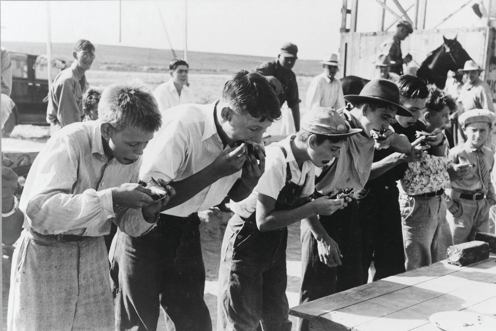 Pie eating contest at 4-H Club fair, Cimarron, Kansas, 1939 Aug. — historic photograph