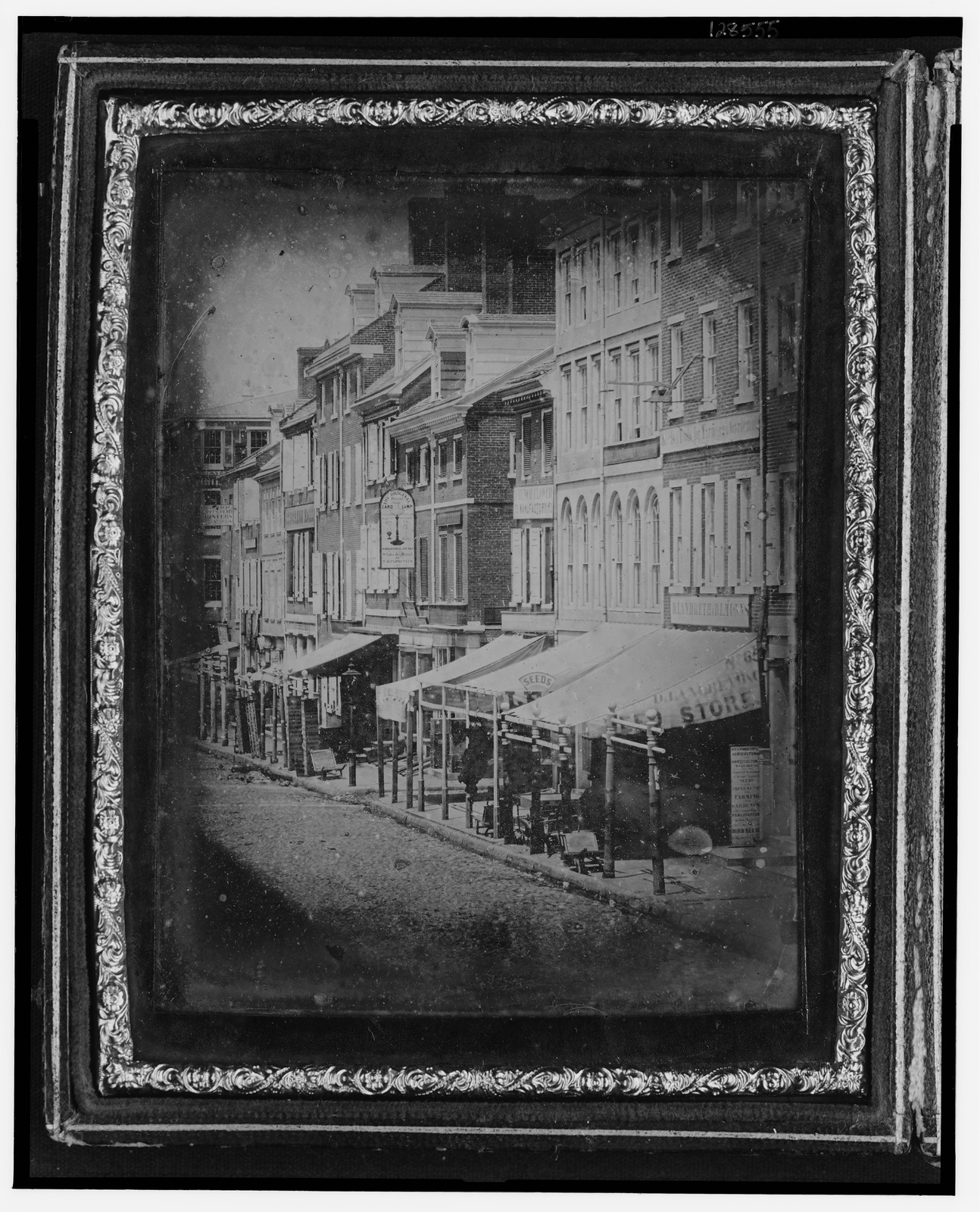 Daguerreotype of a city street with shop awnings, 1842 — historic photograph