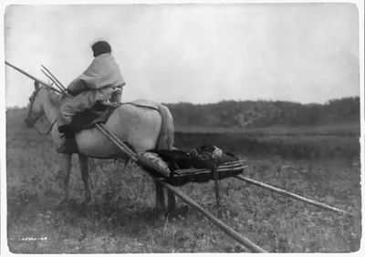[Atsina Indian on horse pulling travois]