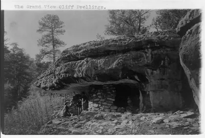 [Grand Canyon and vicinity]: The grand view cliff dwellings [and 3 people]