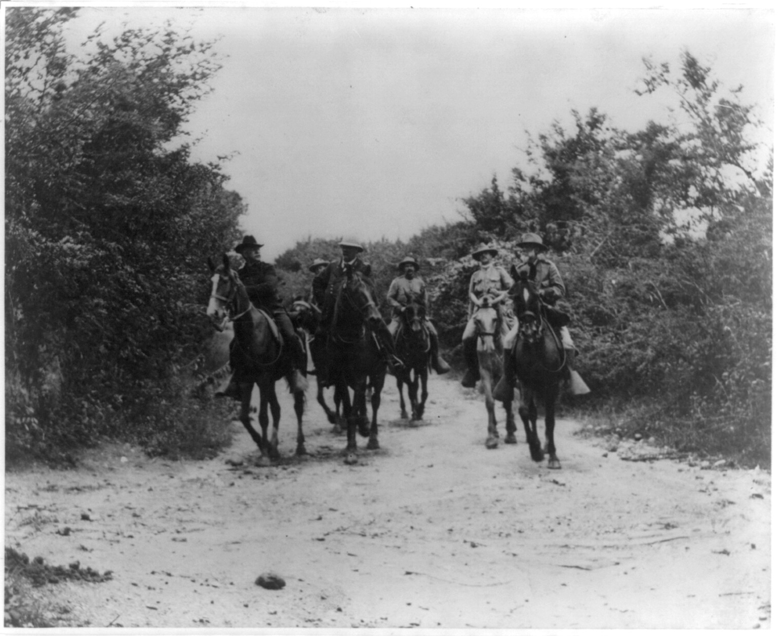 Genral Miles, Shafter, Wheeler [and 3 other soldiers on horeback] returning from the conference with Genral H. Toral which resulted in the surrender of the Province of Santiago de Cuba, c1898. — historic photograph