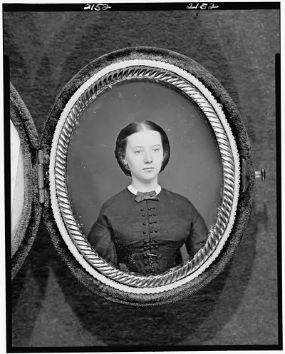 Young woman in oval daguerreotype case, bow tie