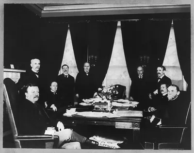 [Theodore Roosevelt, three-quarters length, seated at table, facing right, with cabinet]