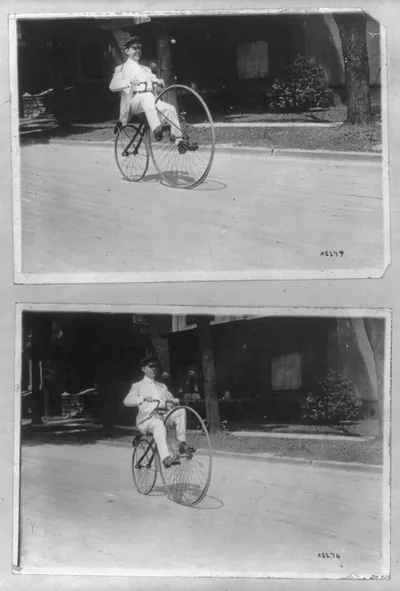 [Man on a bicycle with a large wheel in the front, in the Cadillaqua parade at Detroit, July 23, showng the evolution of the bicycle, in the automobile parade]