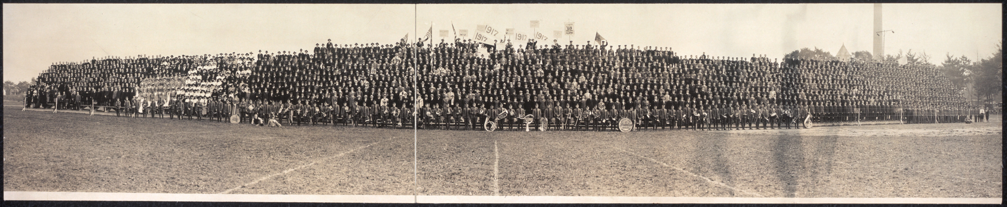 Massed uniformed men on a field, panoramic photograph — historic photograph