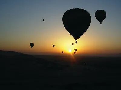 Hot air balloons silhouetted against a sunrise sky