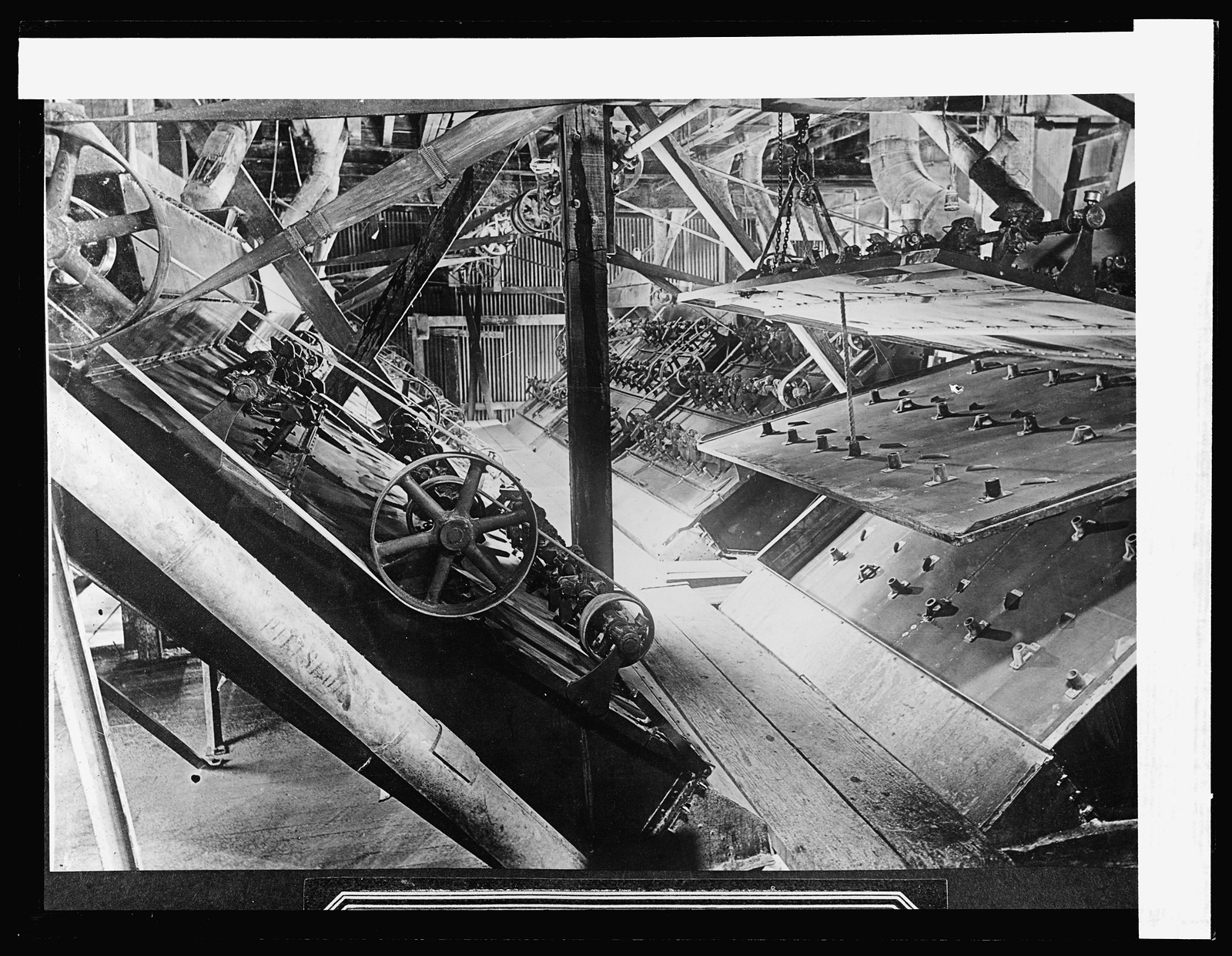 Separators one of which is open, showing three screens for separating the sugar grains, [between 1910 and 1920] — historic photograph