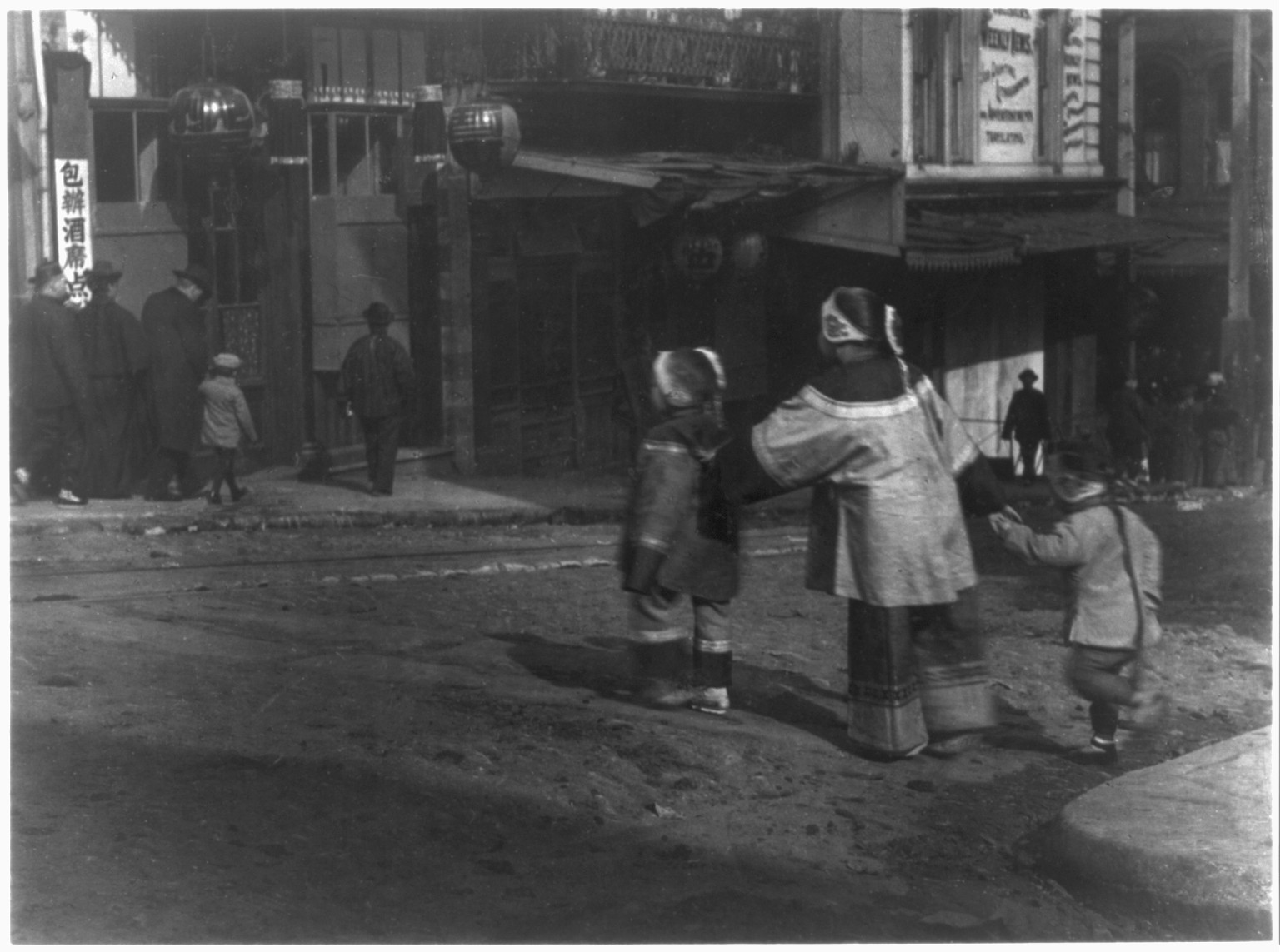 [Chinese in Chinatown, San Francisco: 3 children crossing street holding hands], [no date recorded on caption card] — historic photograph