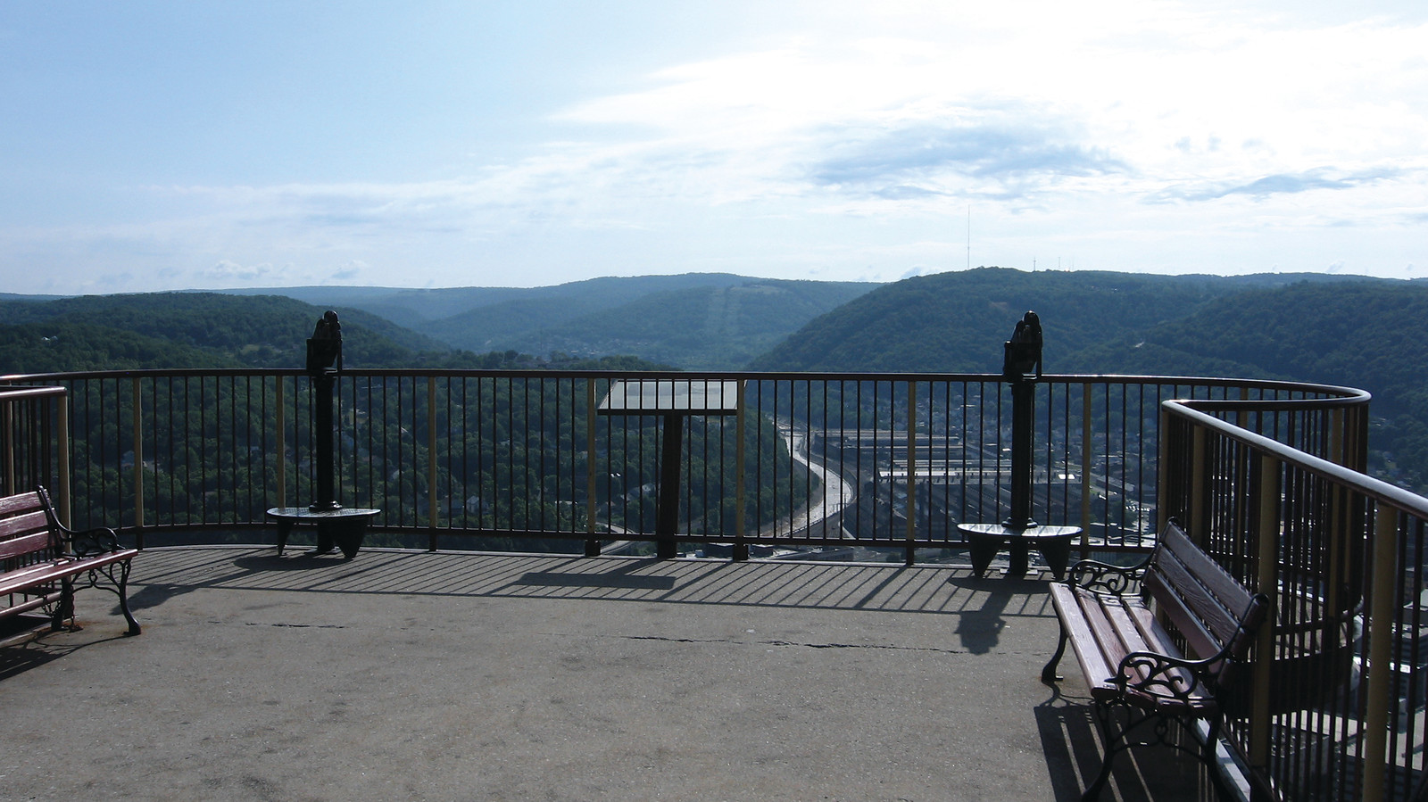 Overlook terrace with benches above a wooded river valley — historic image
