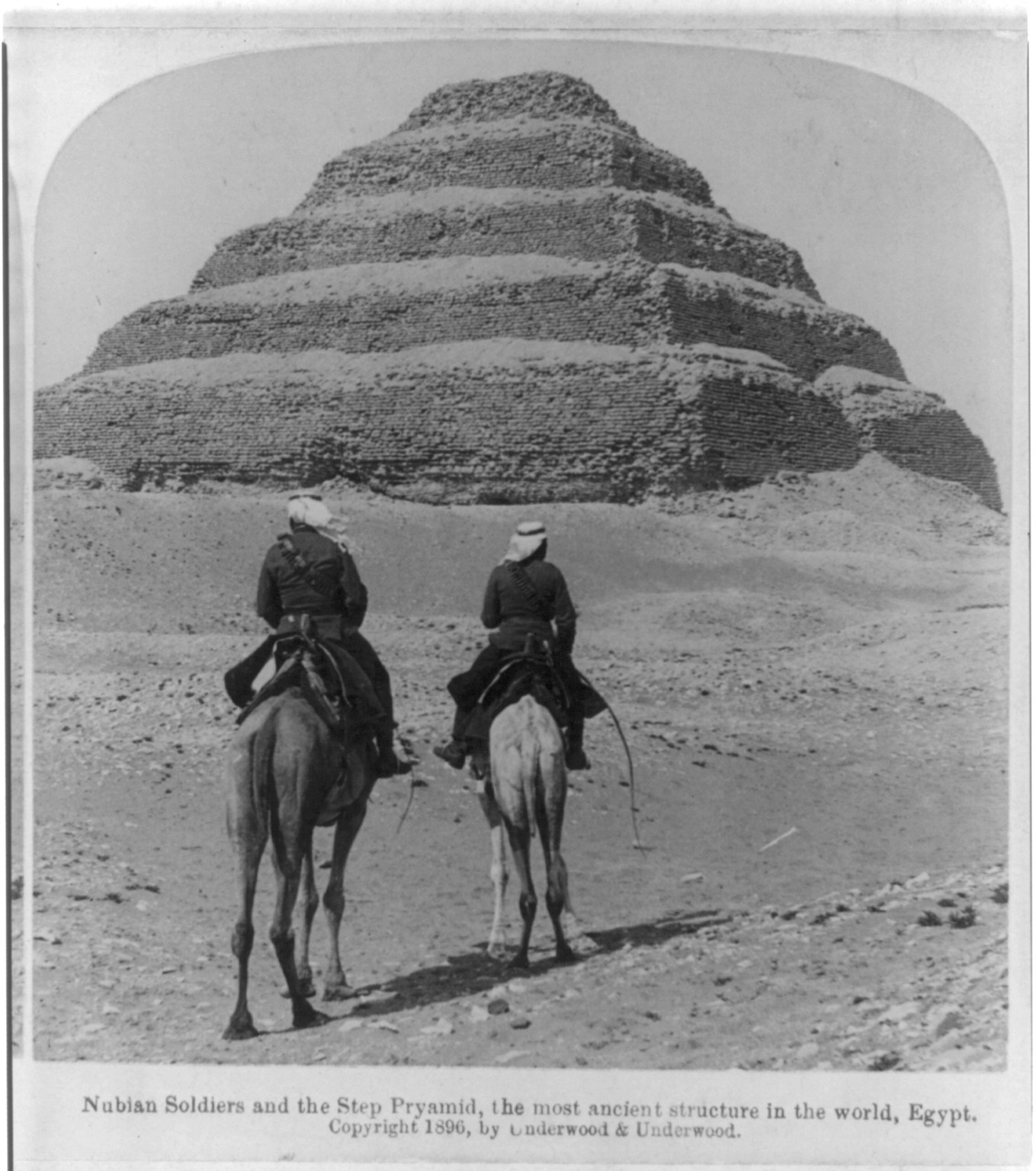 Nubian Soldiers [on camels] and the Step Pyramid, the most ancient structure in the world, Egypt, c1896. — historic photograph