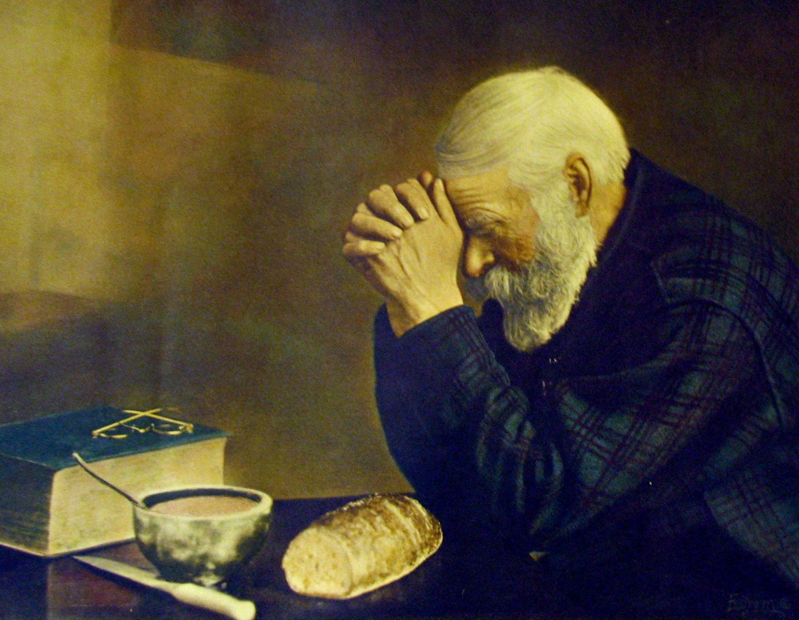 Elderly bearded man praying over bread, soup and Bible — historic image