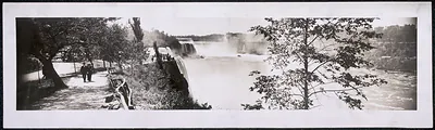 Panoramic black and white photograph of Niagara Falls with a walking path