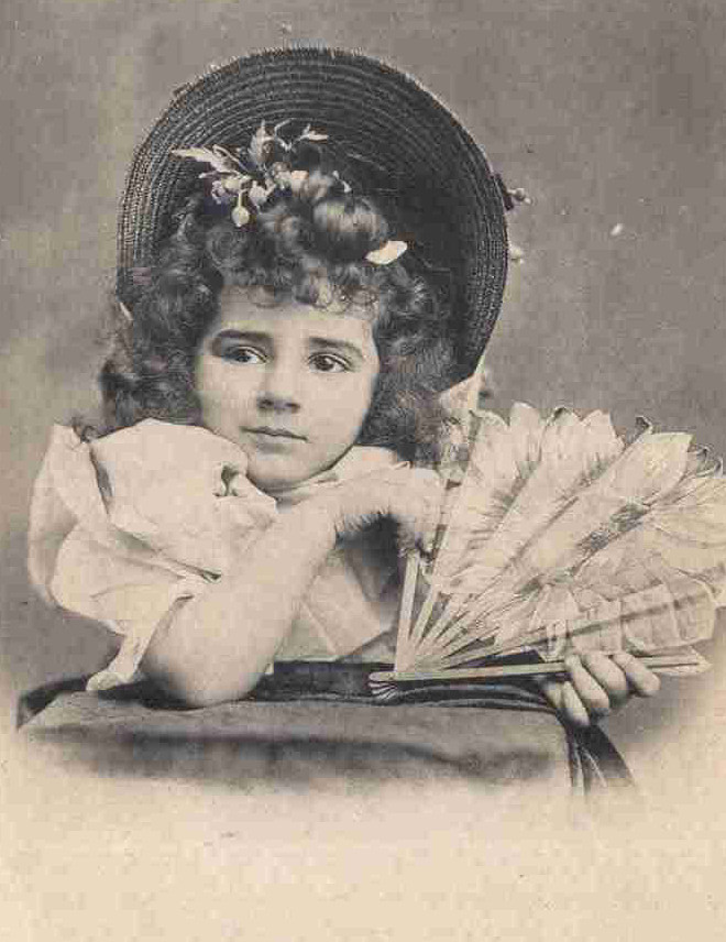 Young girl in straw hat with feather fan — historic image