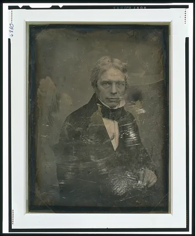 [Michael Faraday, half-length portrait, three-quarters to the right, seated in chair, hand resting on table]