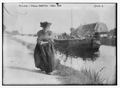 Holland -- woman drawing canal boat pulling