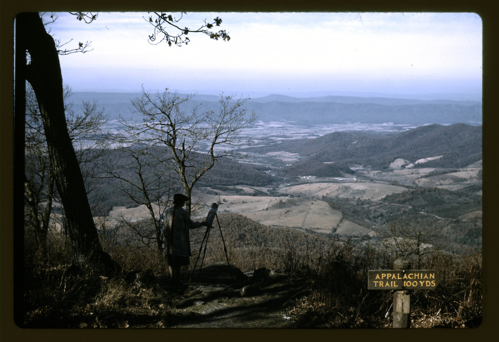 Person with tripod at overlook above valley, Appalachian Trail sign — historic image