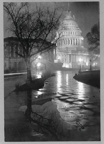 [View of the U.S. Capitol, at night, in rain]