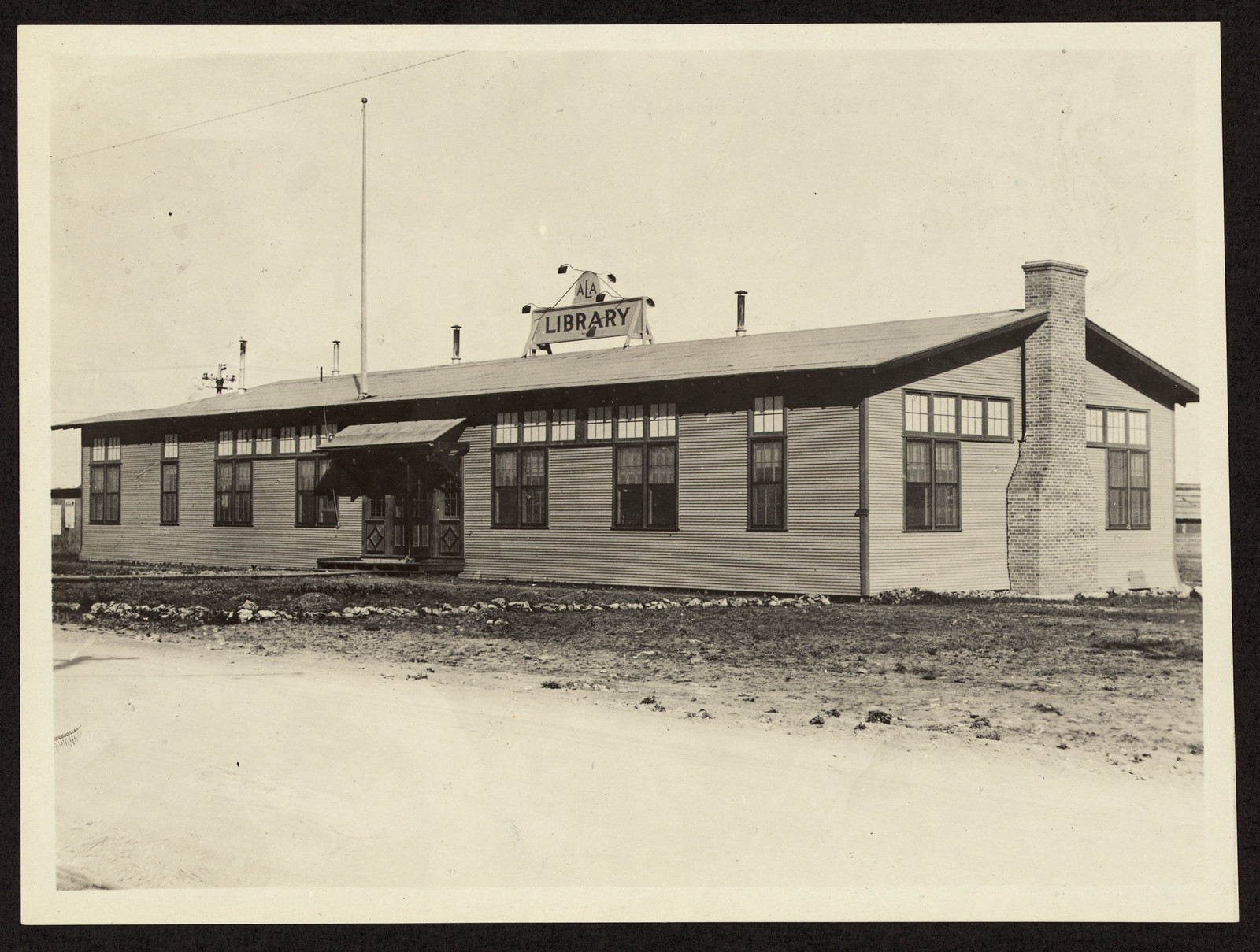 Library building with ALA and LIBRARY sign on roof — historic image