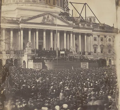 Large crowd before the Capitol east front, dome under construction