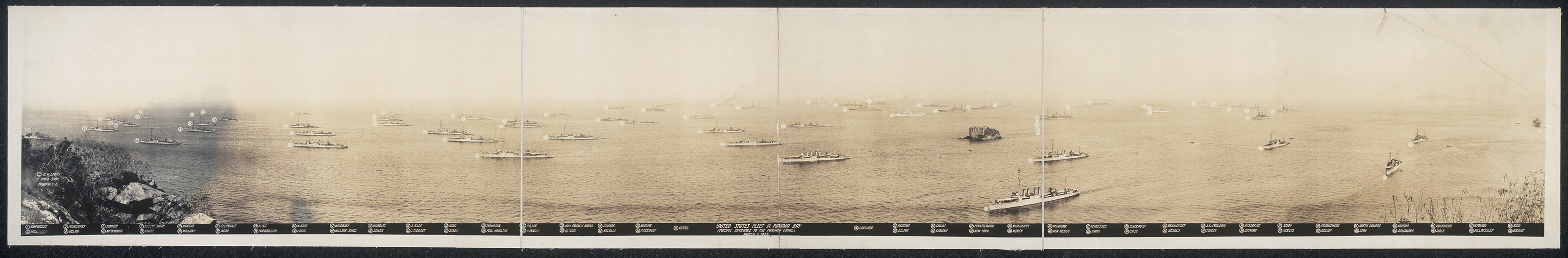 Panoramic photograph of a naval fleet at anchor on open water — historic photograph