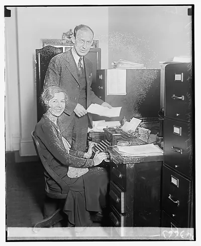 [Unidentified man and woman at desk with typewriter]