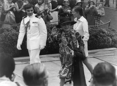 Mrs. Nicholas Longworth and Miss Joanna Sturm escorted by a White House Social Aide arriving at the East Gate of the White House [for the wedding of Tricia Nixon and Edward Cox]