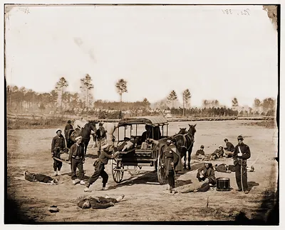 Zouave ambulance crew demonstrating removal of wounded soldiers from the field
