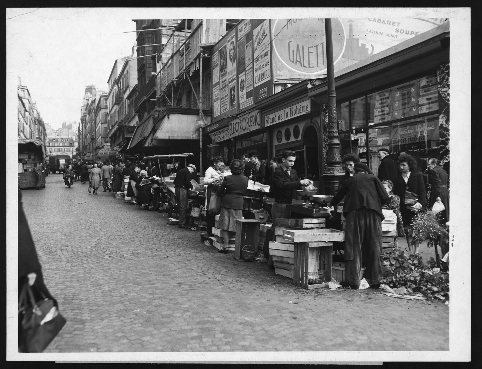 Busy Paris street market with produce crates and stalls — historic image